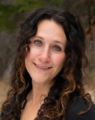 smiling woman with long dark curly hair, Dr Hailey Martinez